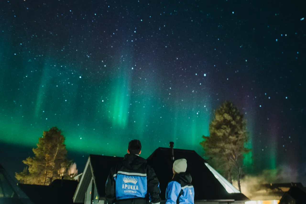 Northern lights above an Aurora Cabin glass igloo at Apukka Resort, Rovaniemi